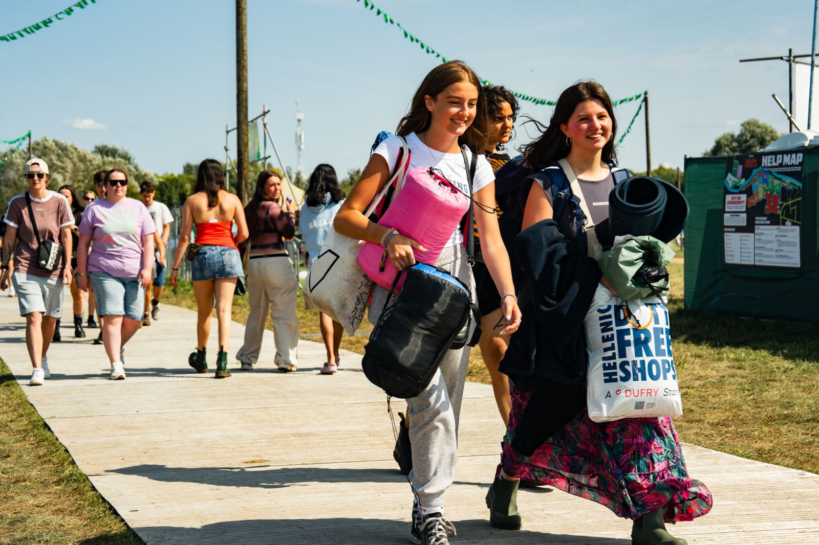 Girls carrying sleeping bags at Reading Festival