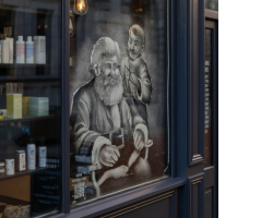 Snow window of Santa having his hair cut
