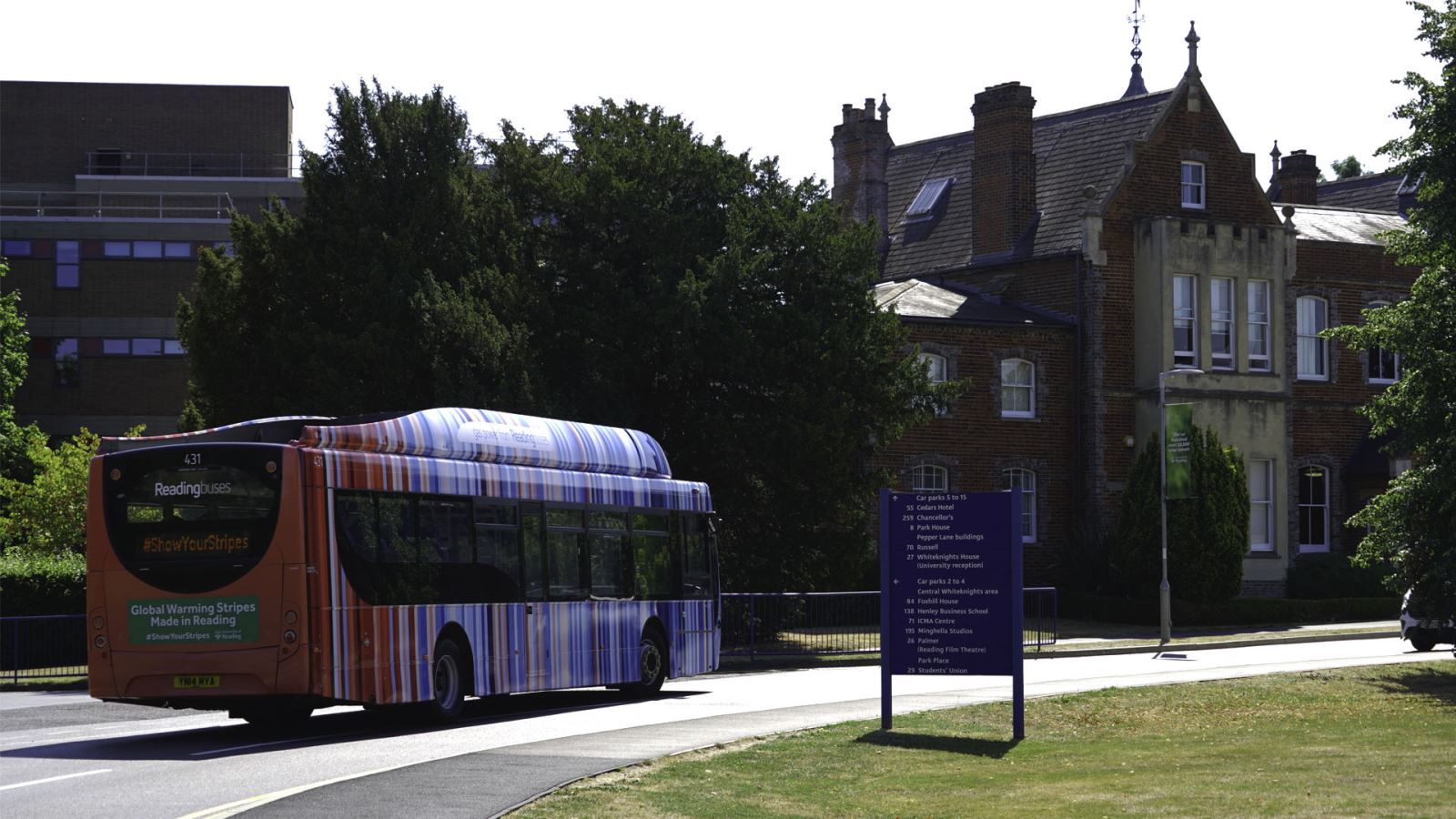 Reading Bus wrapped with Climate Stripes, driving through Reading University