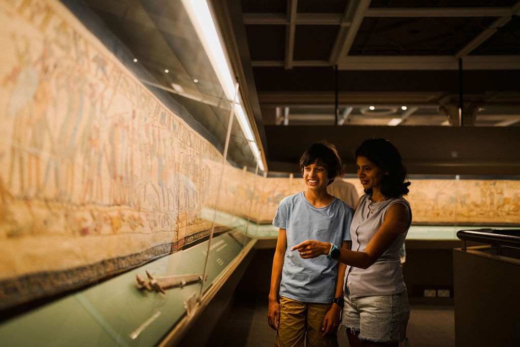 Mother and son looking at Bayeux Tapestry in Reading Museum