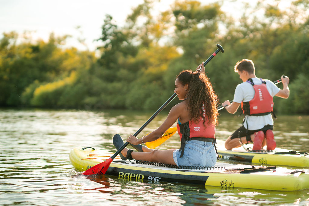 Man and woman paddleboarding