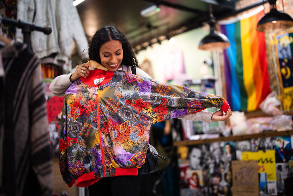 Woman holding up a jacket to herself