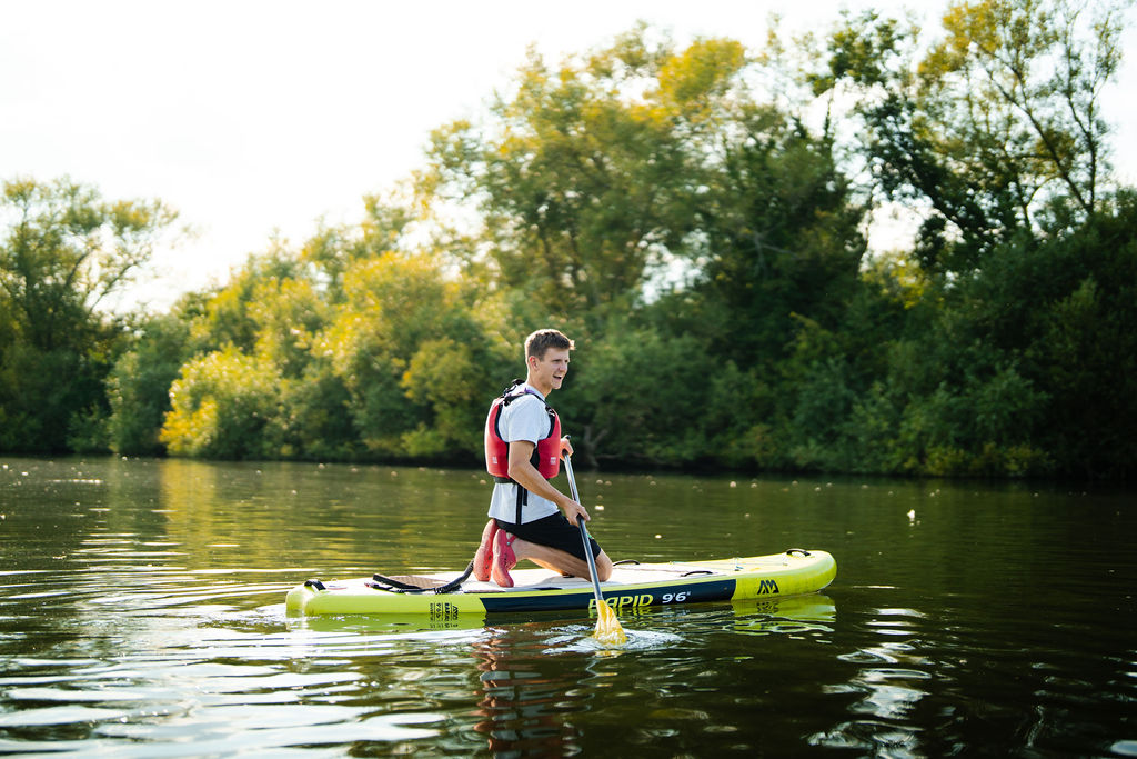 Young man on a paddleboard on River Thames