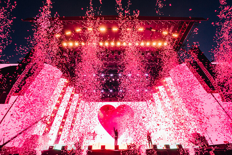 Bring Me The Horizon on stage with pink confetti and a heart on the screen