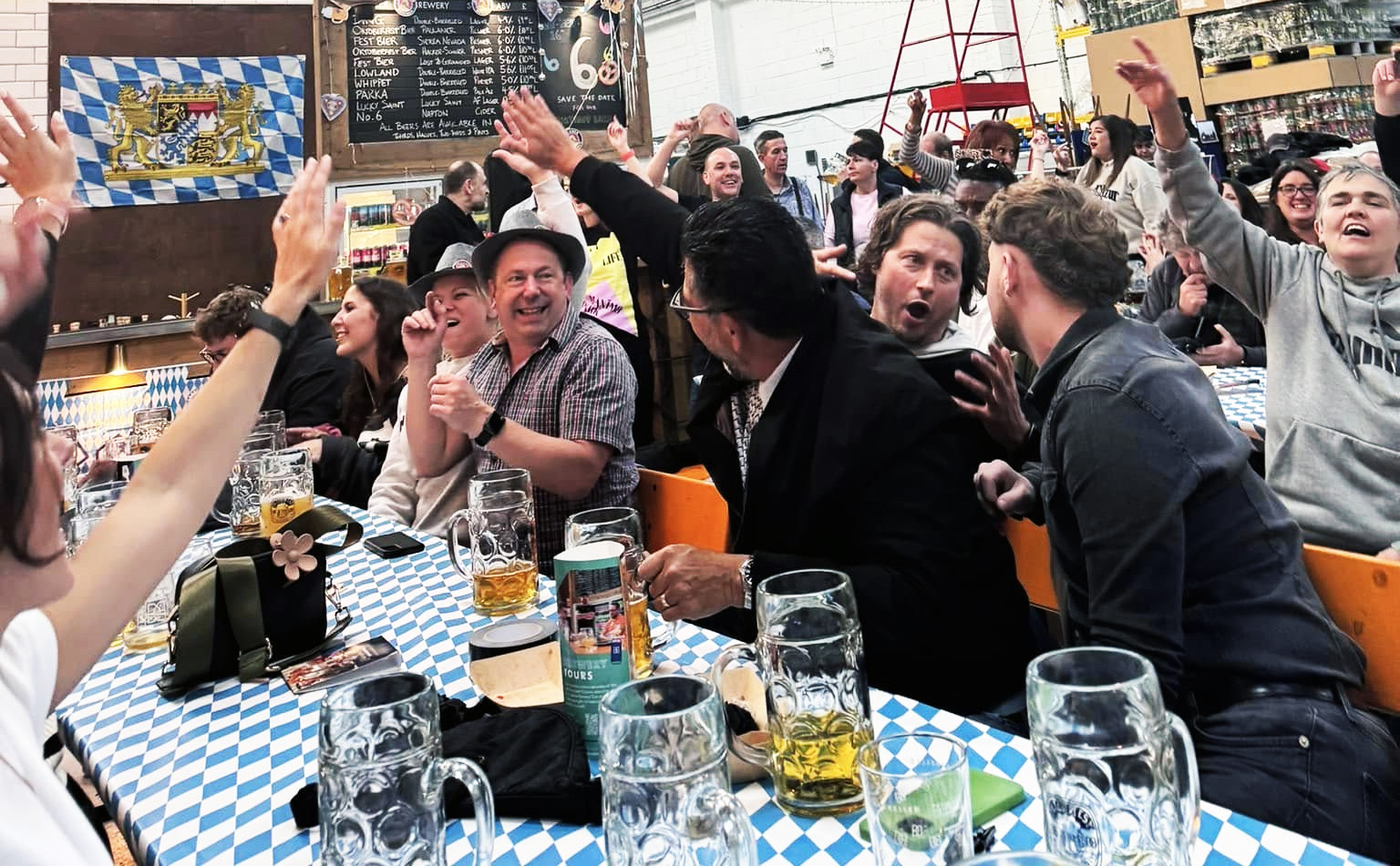 Pub full of people smiling and drinking